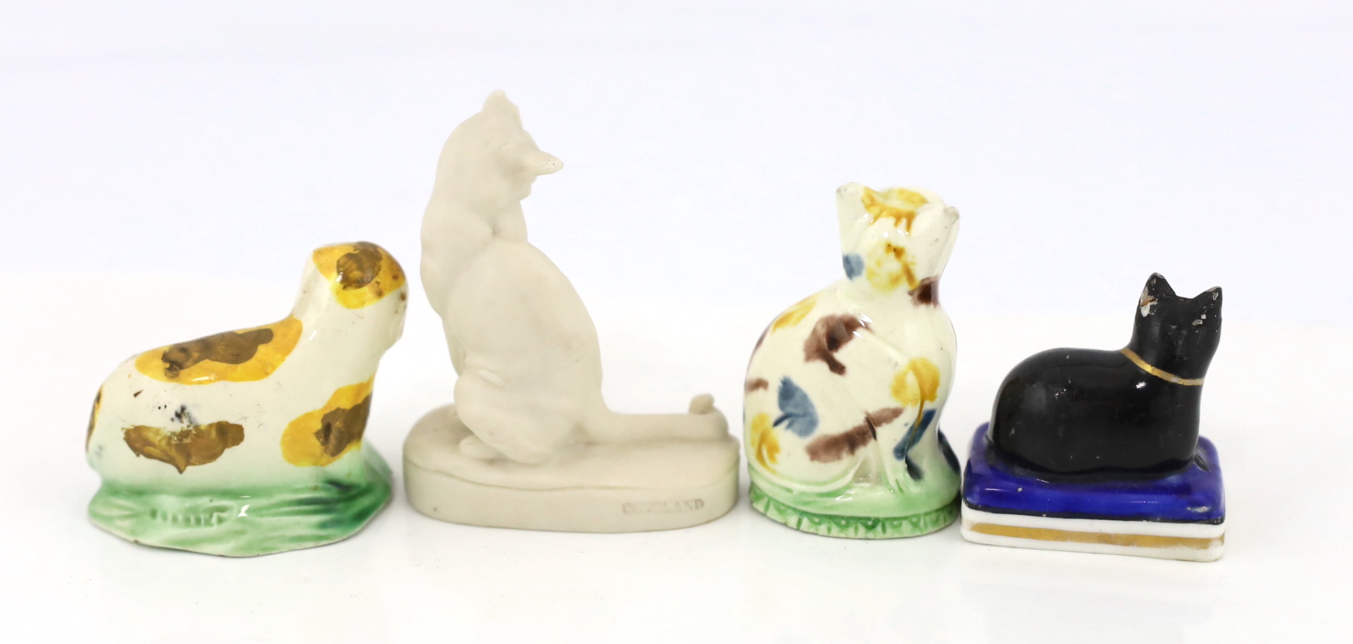 Two Staffordshire creamware models of a seated cat and a recumbent dog, c.1780